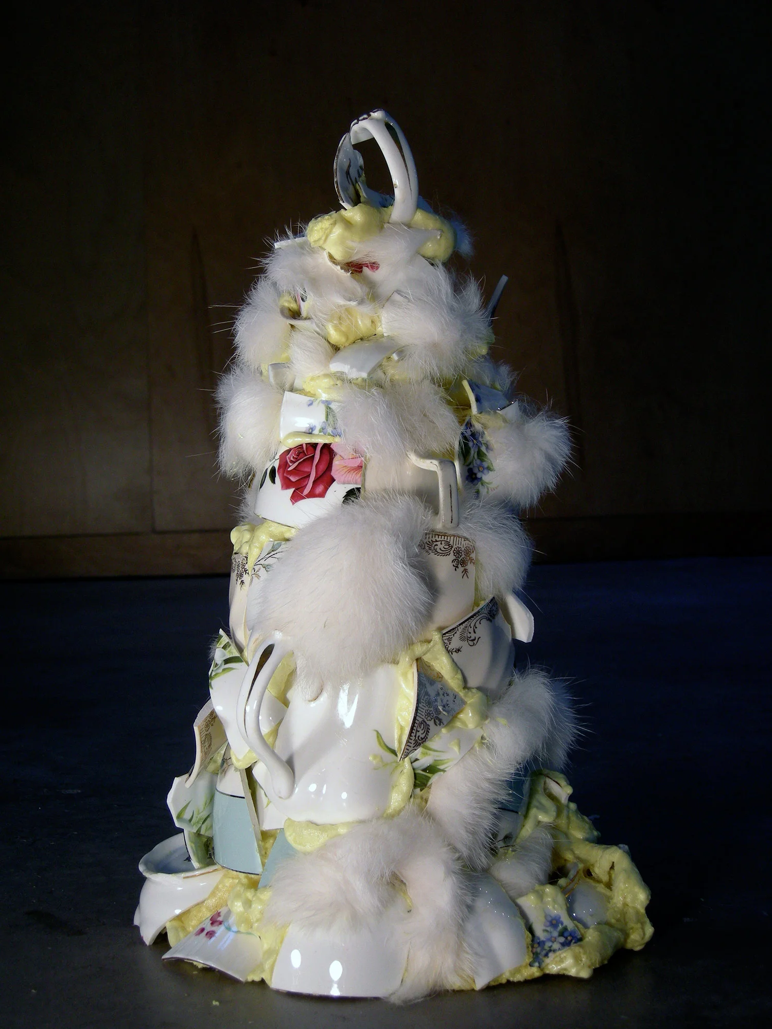 stalagmite: spray foam, broken china cups, wild trapped fur - 11 in high x 16 in circumference