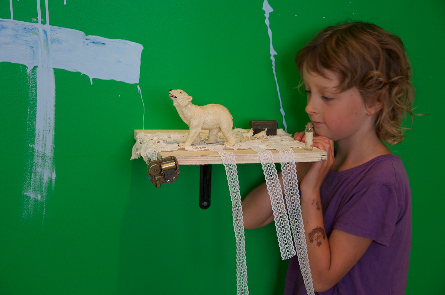 She asked for one small square shelf and commenced to build her world in miniature.