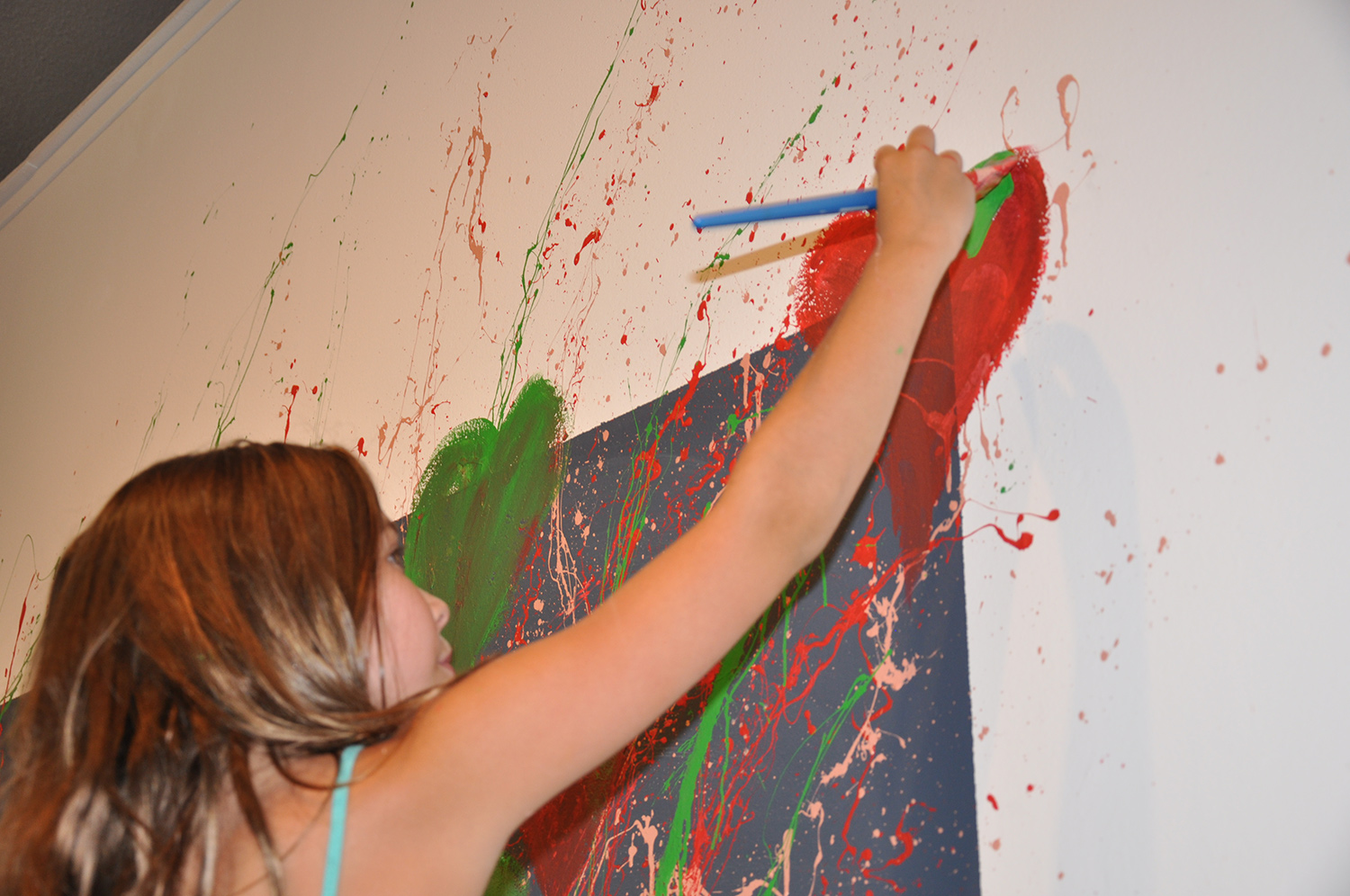 Mackenzie wanted to fill up the space around Talyn's painting. Unabashed and energetic splatter painting lead to a heart filled explosion.