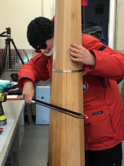 Gwen, a trained cellist, checks the calibration of the fully strung instrument.
