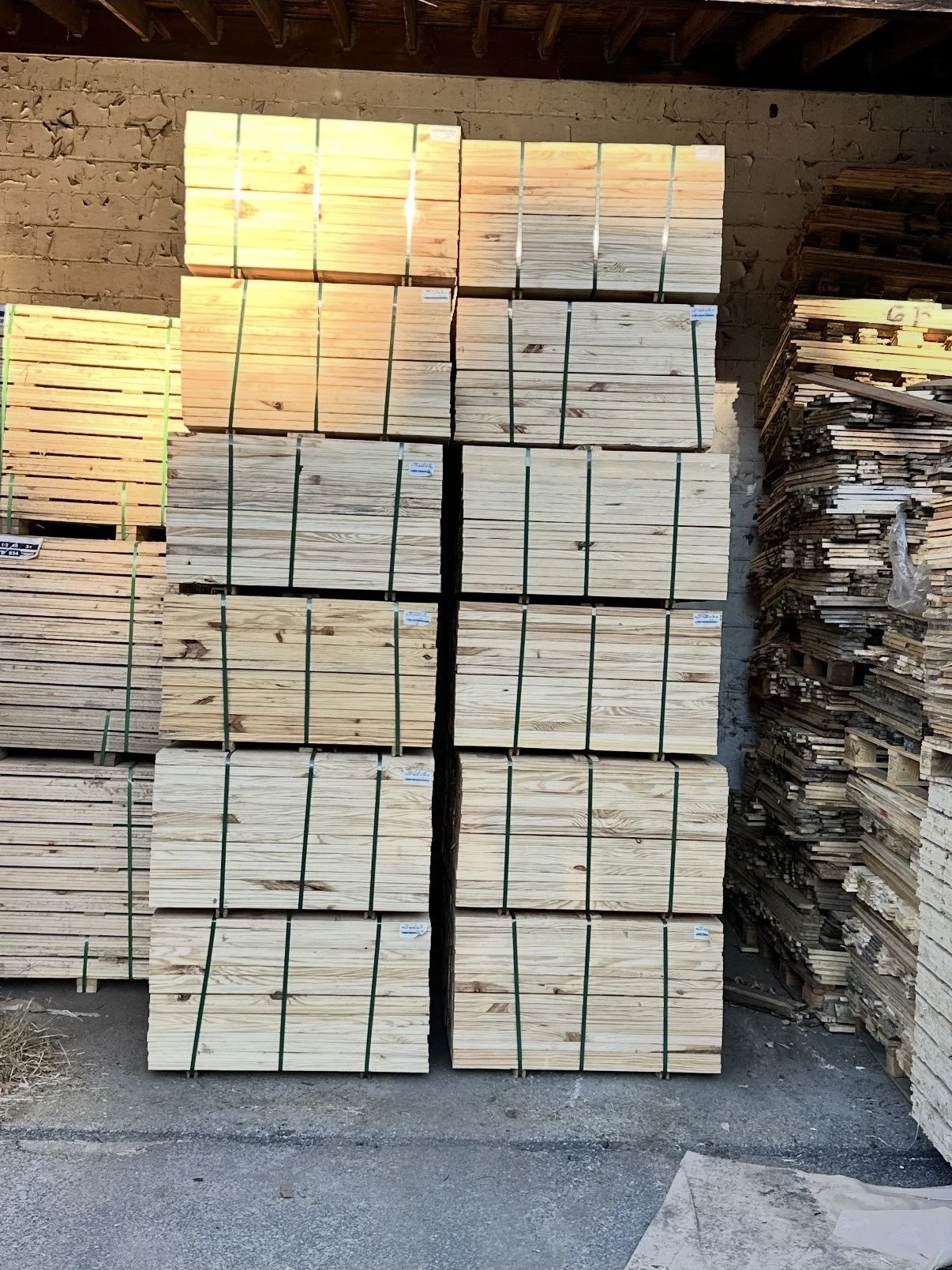 Stacks of wooden planks and lumber in a hardware store or lumberyard.
