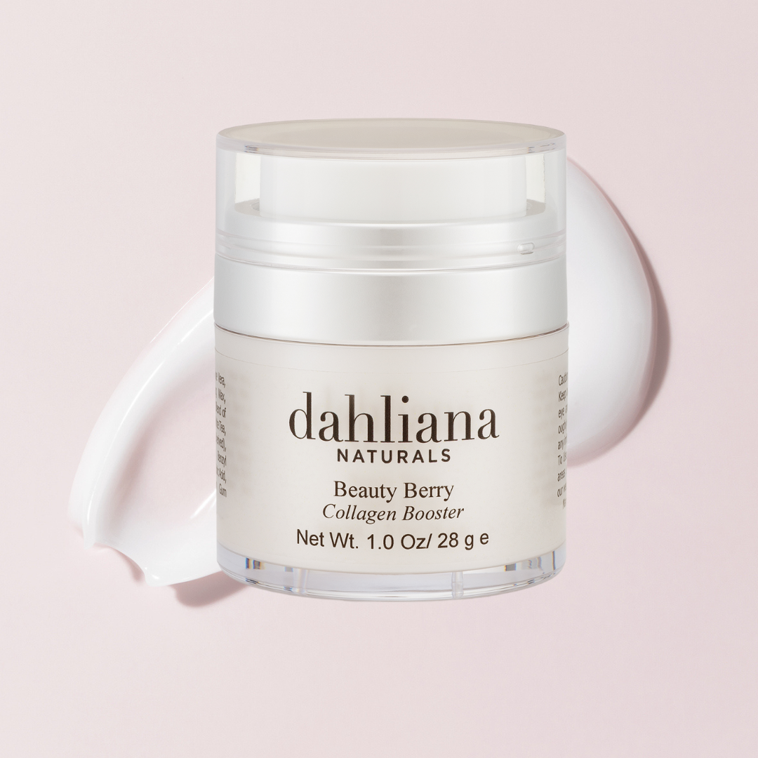 A jar of Dahliana Naturals Beauty Berry Collagen Booster cream on a light pink background.