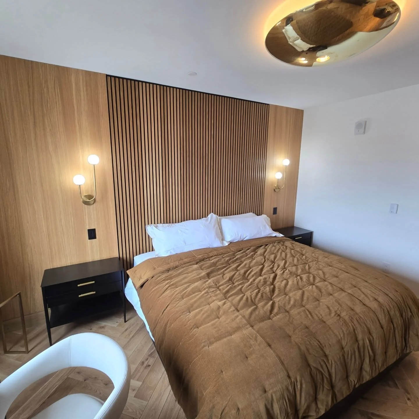 Shinnoki Natural White Oak wall panels and closet with a custom made white oak sliding door.  #nicholsoninteriors #customcabinetry #shinnoki