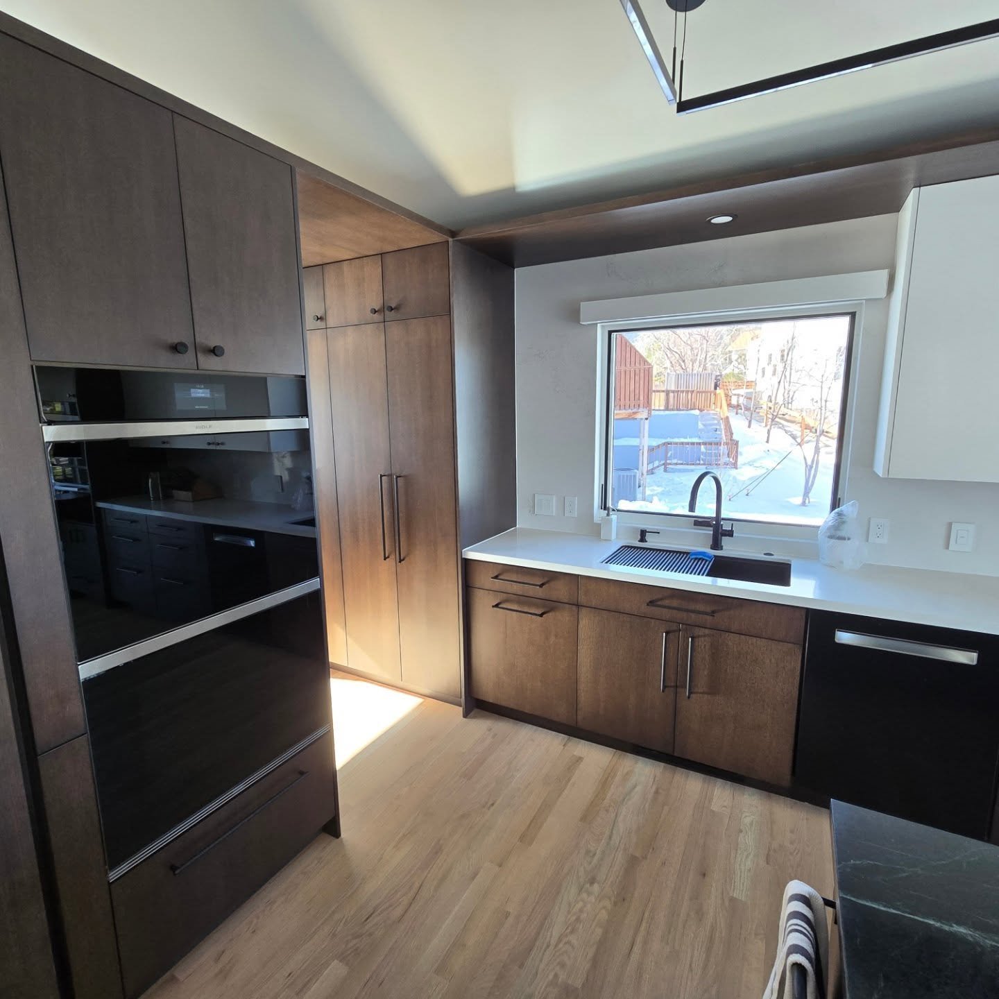 We got a call from a local builder to help fix a disastrous finishing and installation job by another local cabinetry company.  The original finish was done improperly and the clear coat over a dark stain completely changed color and gave the finish 