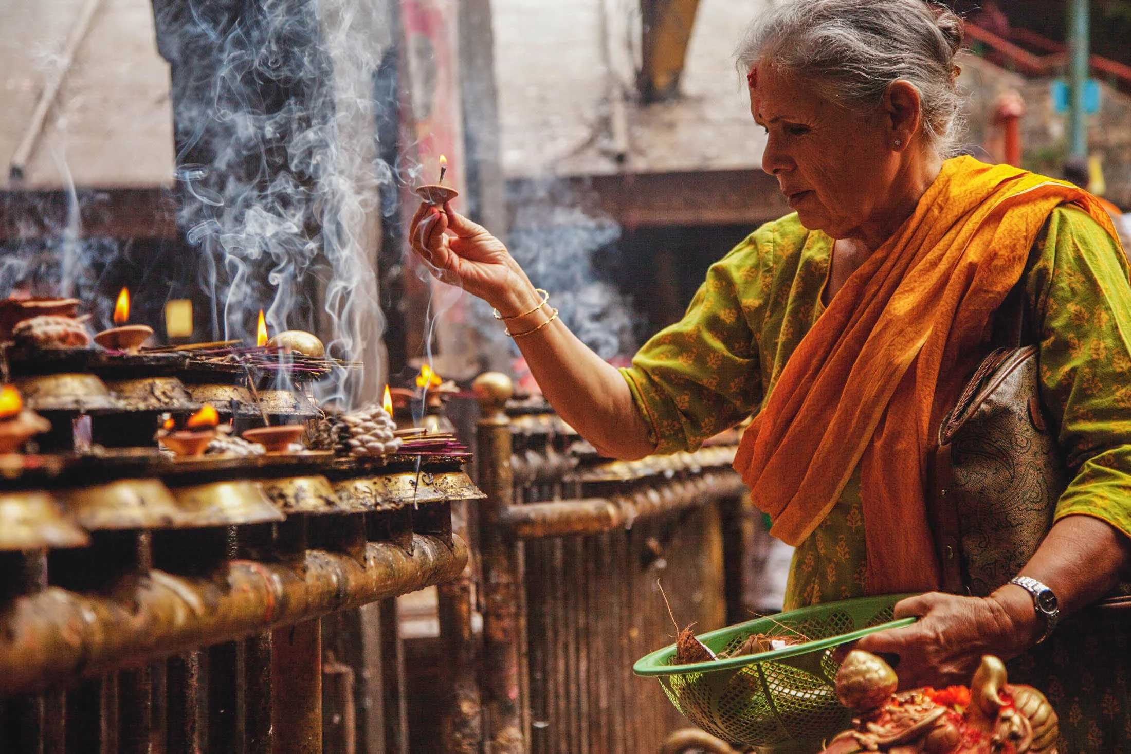 A Hindu worshiper lights candles to gain blessing from Hindu gods at a temple in Nepal. Photo from IMB Photo Library.