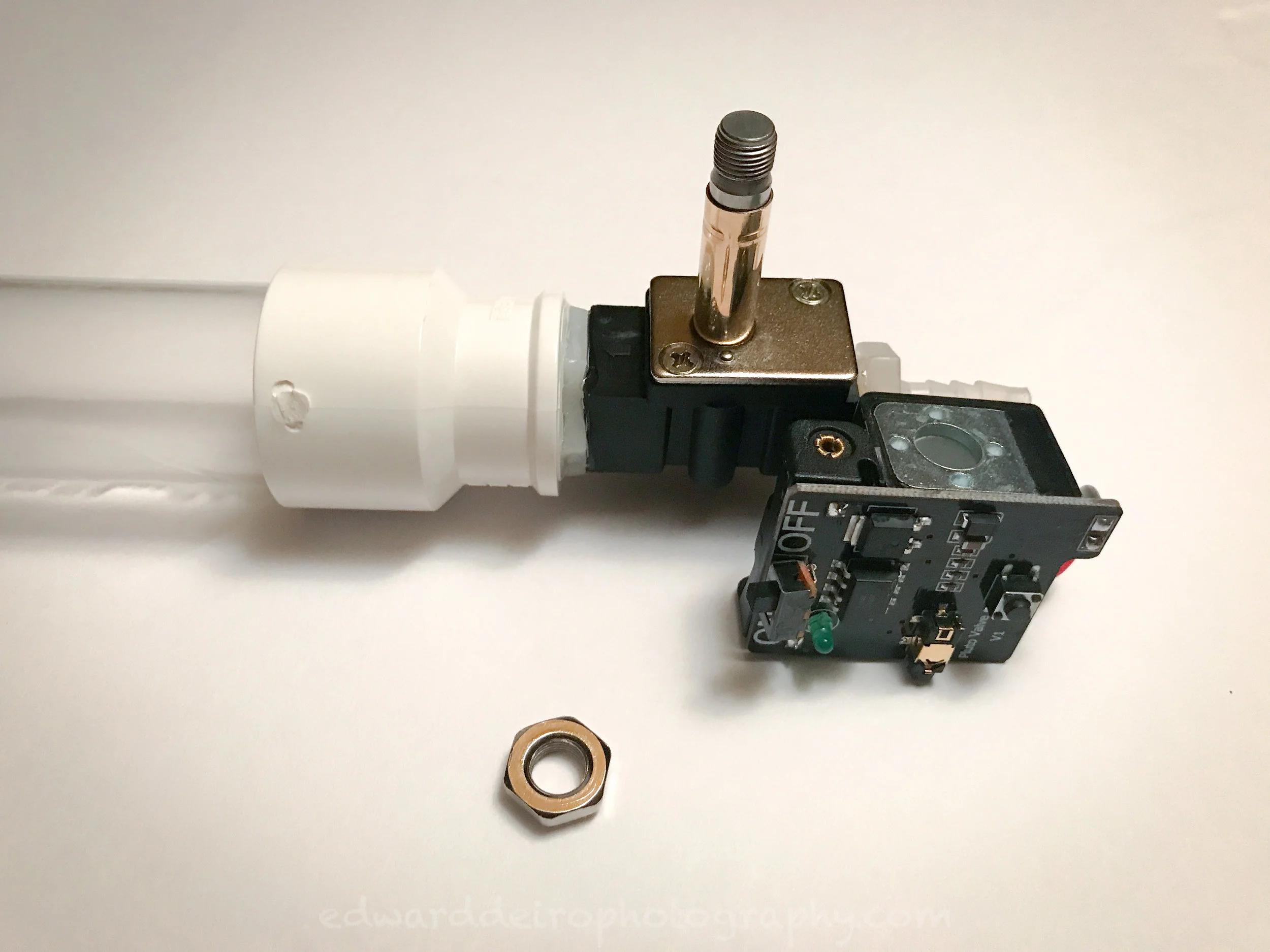 The body/plunger assembly on the top, the electronic circuit board and solenoid middle right and the 14mm nut.