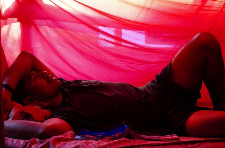 Celso Under A Mosquito Net, Bacalar Chico Dive Camp, Belize, 2019
