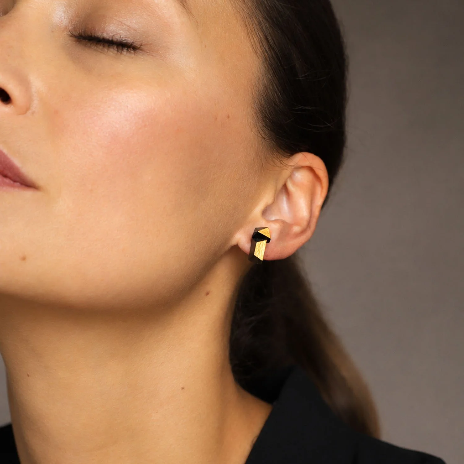 Faceted-leather-stud-earrings-black-gold-modelled-Tania-Clarke-Hall.jpg