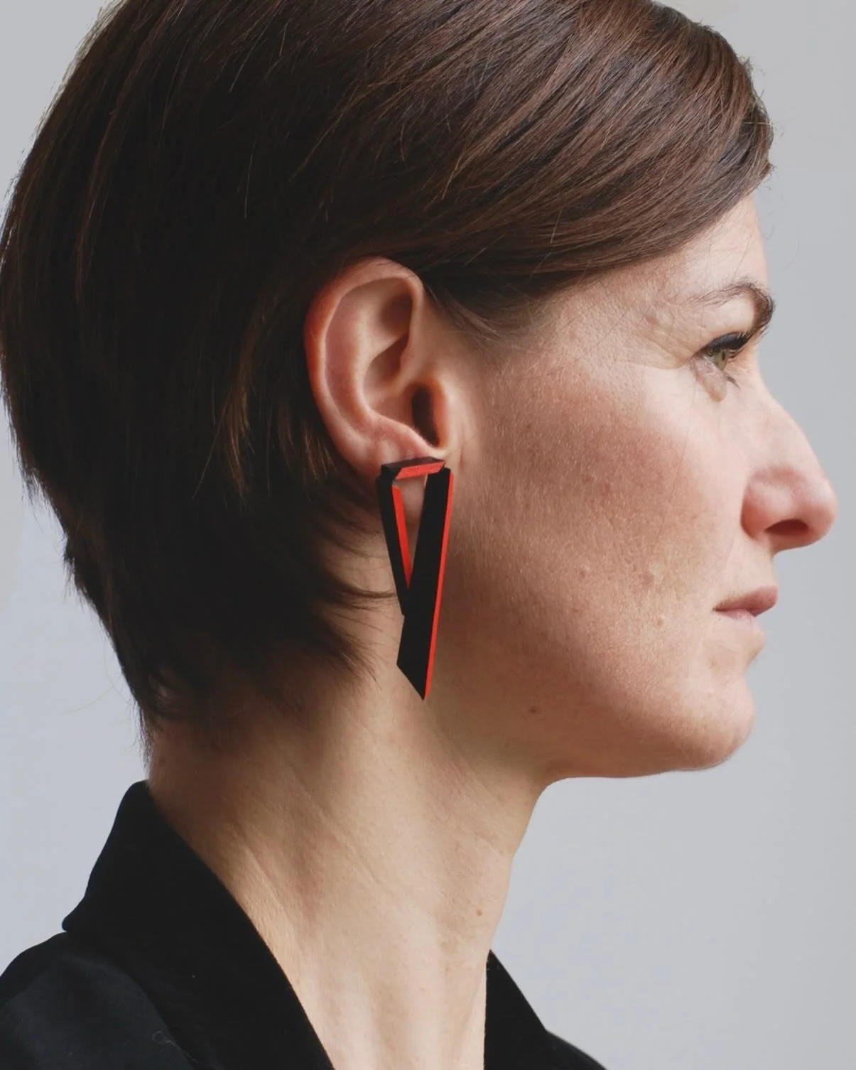 &lsquo;Angular&rsquo; earrings in red - modelled by a friend - are one my favourite earring designs - intersecting edges in red on a tapering triangular leather form.

I love to wear these on days when work transitions into an evening out - elegant f