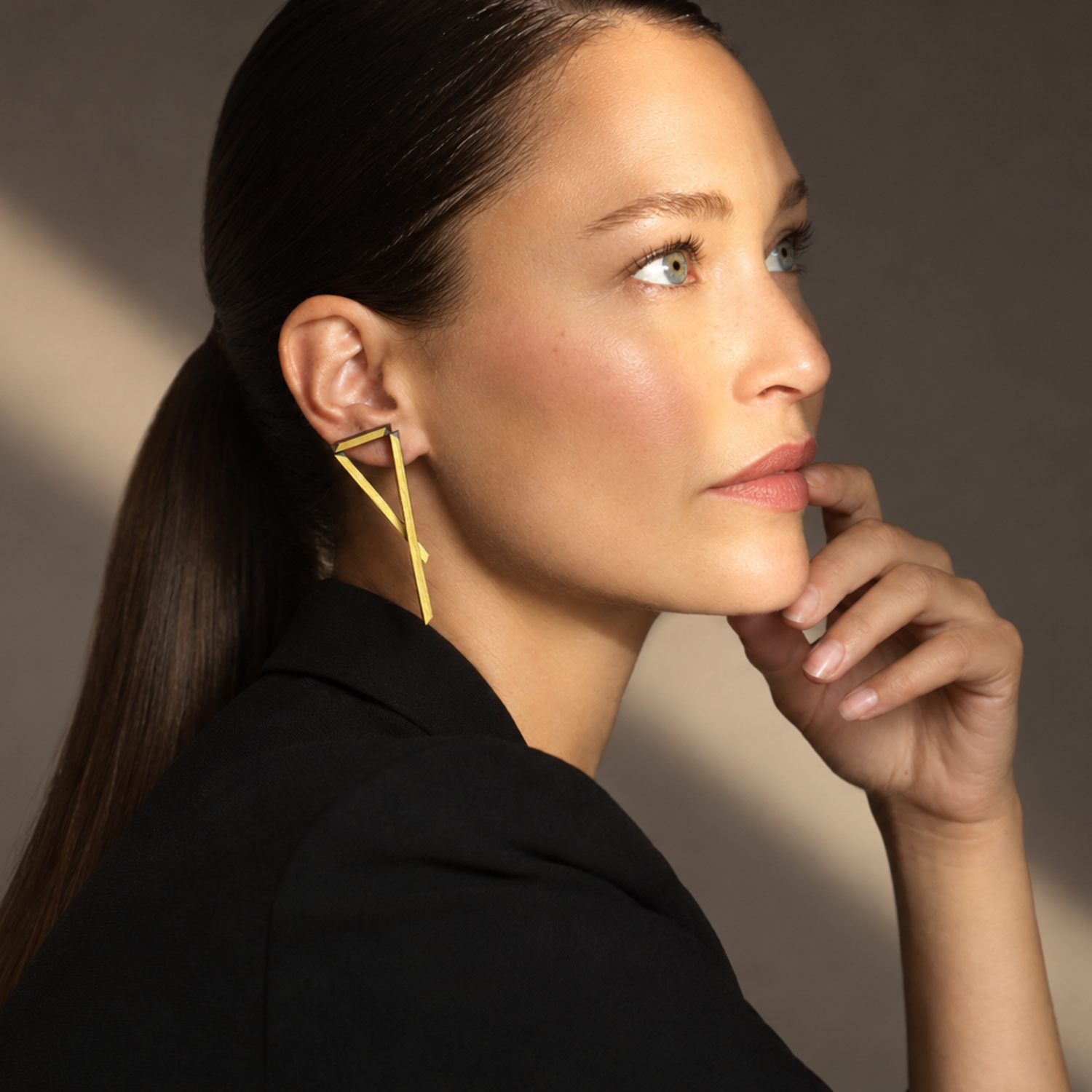 Triangulation-leather-earring-black-gold-Tania-Clarke-Hall-modelled2.jpg