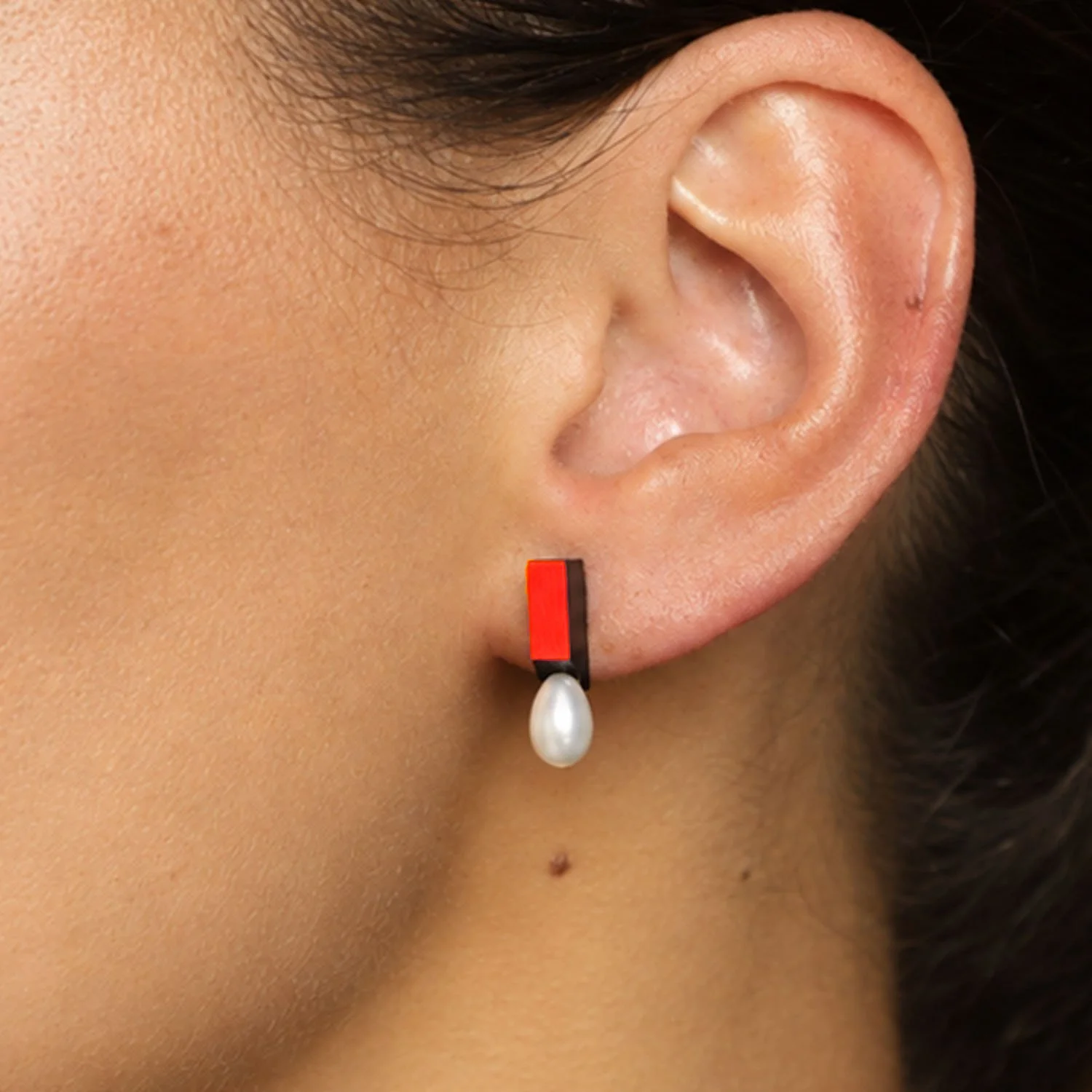 Medal-pearl-leather-stud-earring-black-red-Tania-Clarke-Hall-modelled-detail.jpg