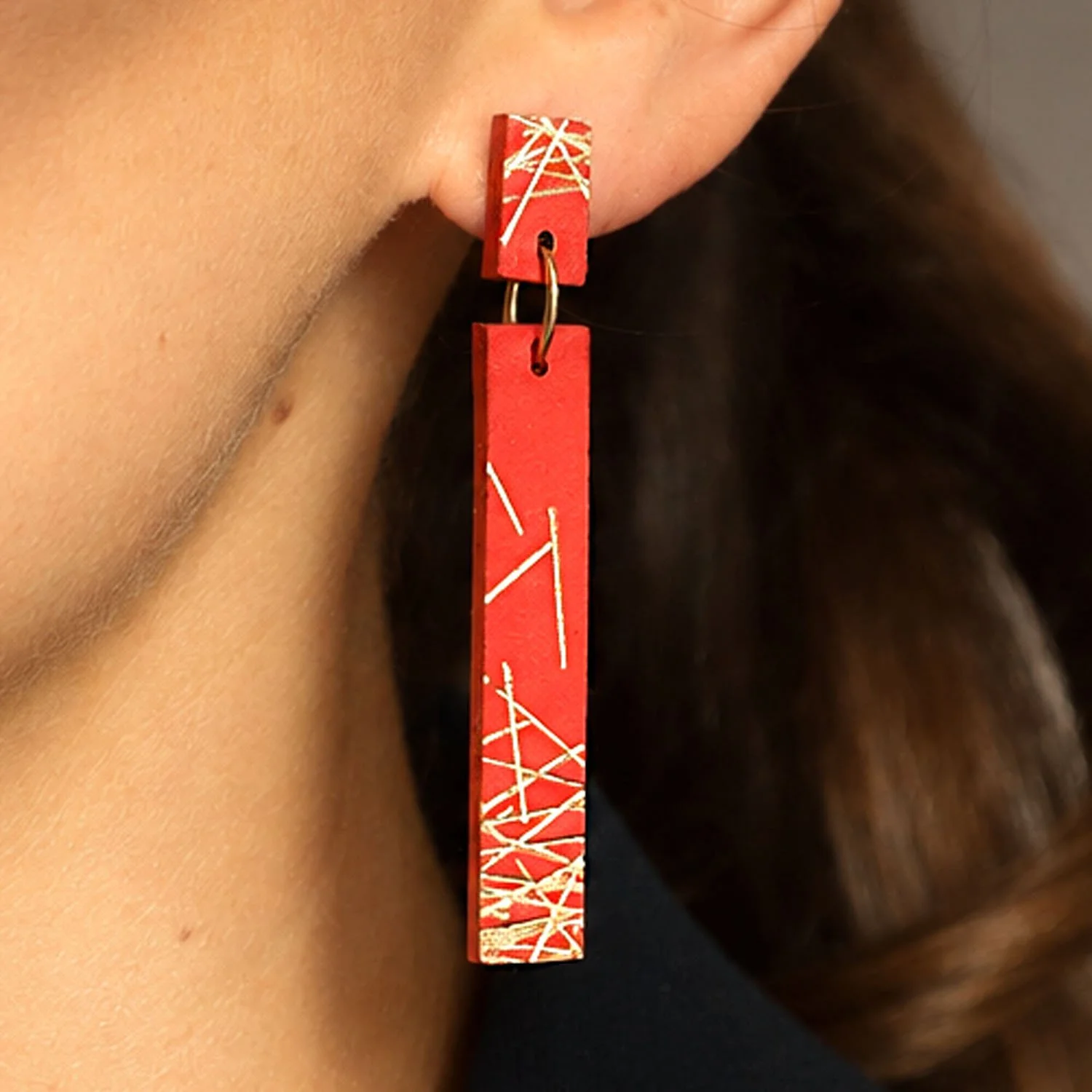 Freehand-lines-leather-earrings-red-gold-Tania-Clarke-Hall-modelled-detail.jpg