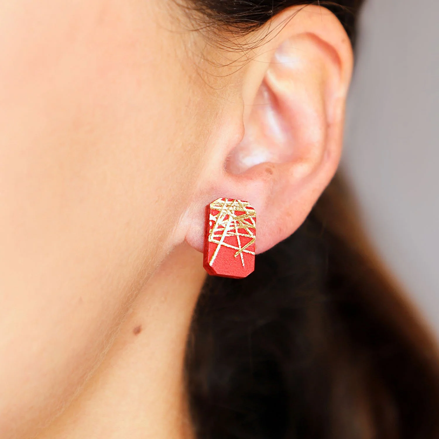Freehand-rectangular-leather-stud-earrings-red-gold-Tania-Clarke-Hall-modelled-detail.jpg