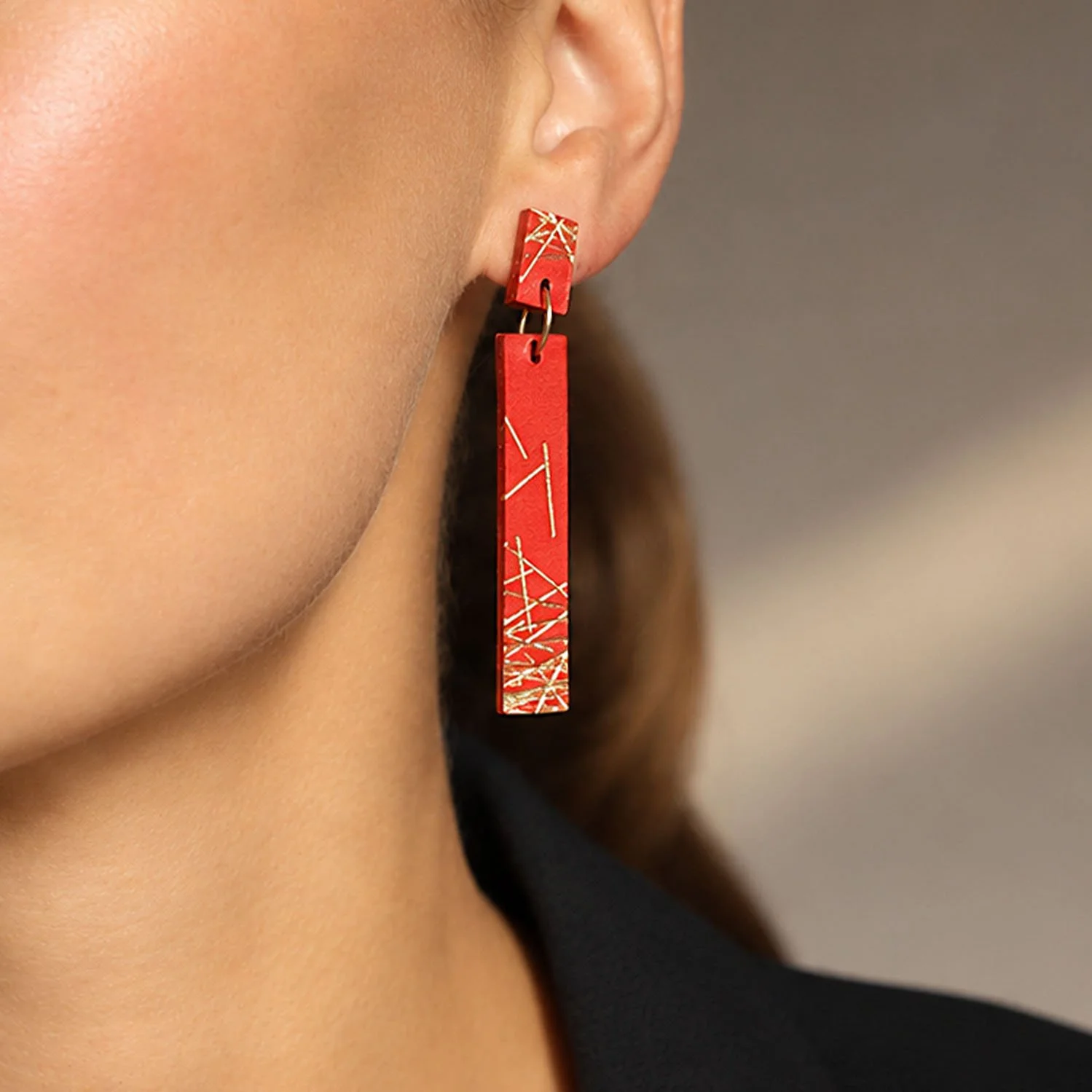 Freehand-lines-leather-earrings-red-gold-Tania-Clarke-Hall-modelled-detail2.jpg