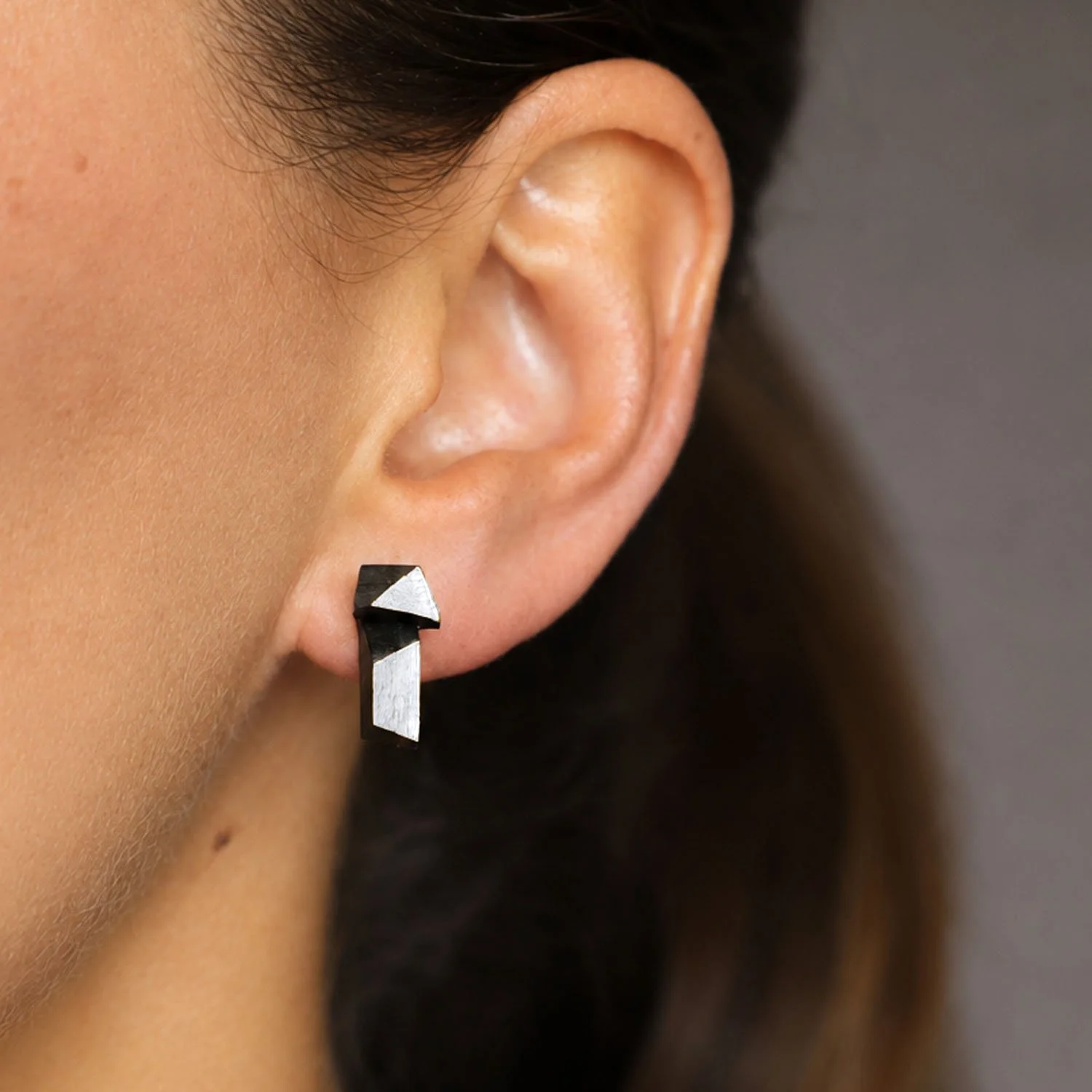 Faceted-leather-stud-earrings-black-silver-modelled-Tania-Clarke-Hall-detail.jpg