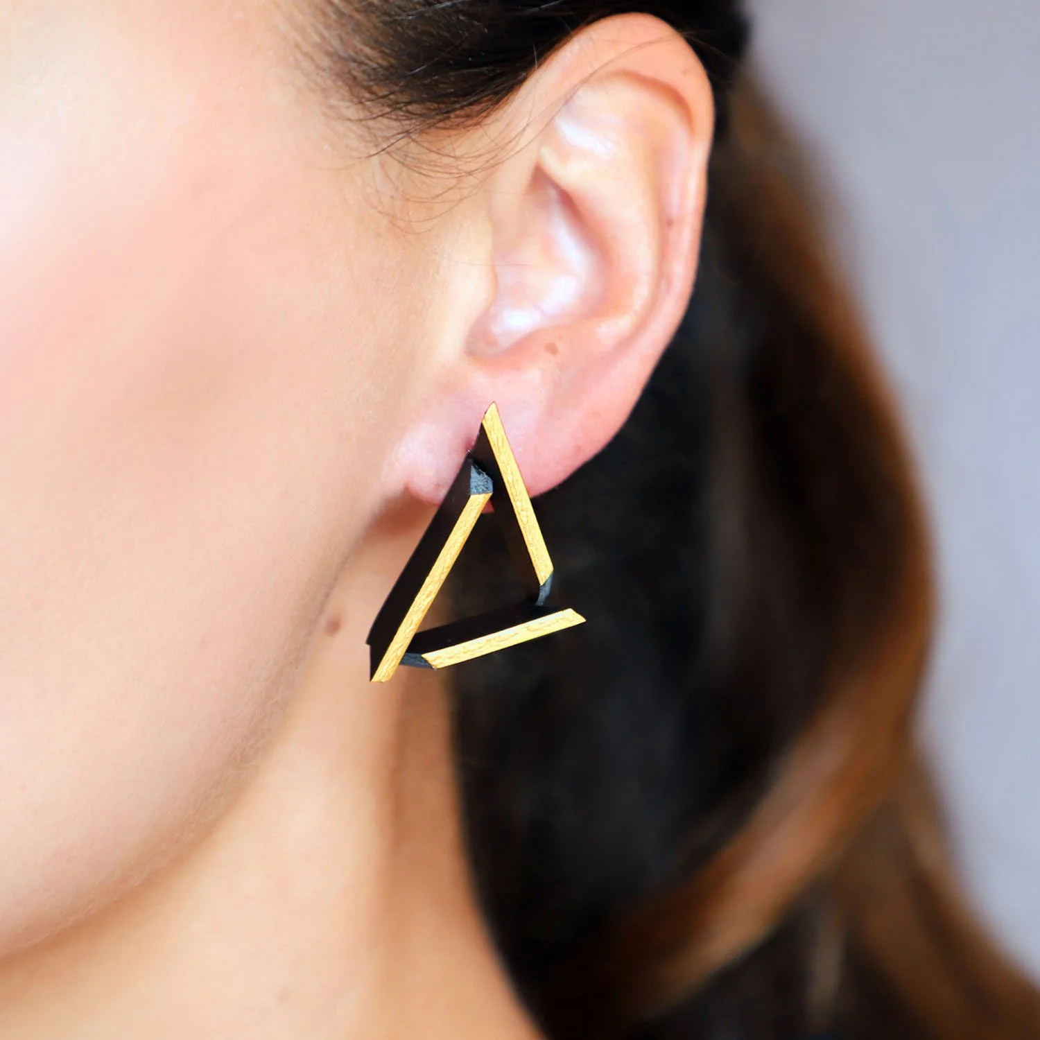 Triangle-leather-earrings-black-gold-Tania-Clarke-Hall-modelled-detail.jpg