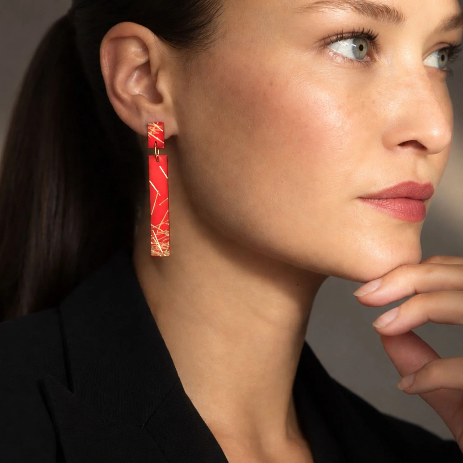 Freehand-lines-leather-earrings-red-gold-Tania-Clarke-Hall-modelled.jpg