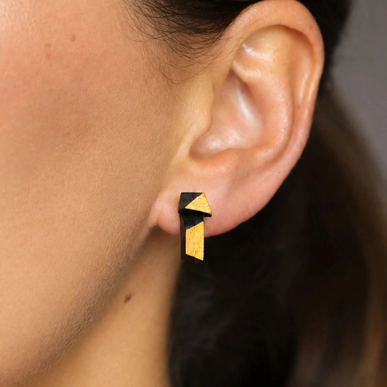 Faceted-leather-stud-earrings-black-gold-modelled-Tania-Clarke-Hall-detail.jpg