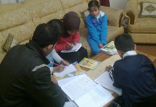 One of the university students who is teaching some school students