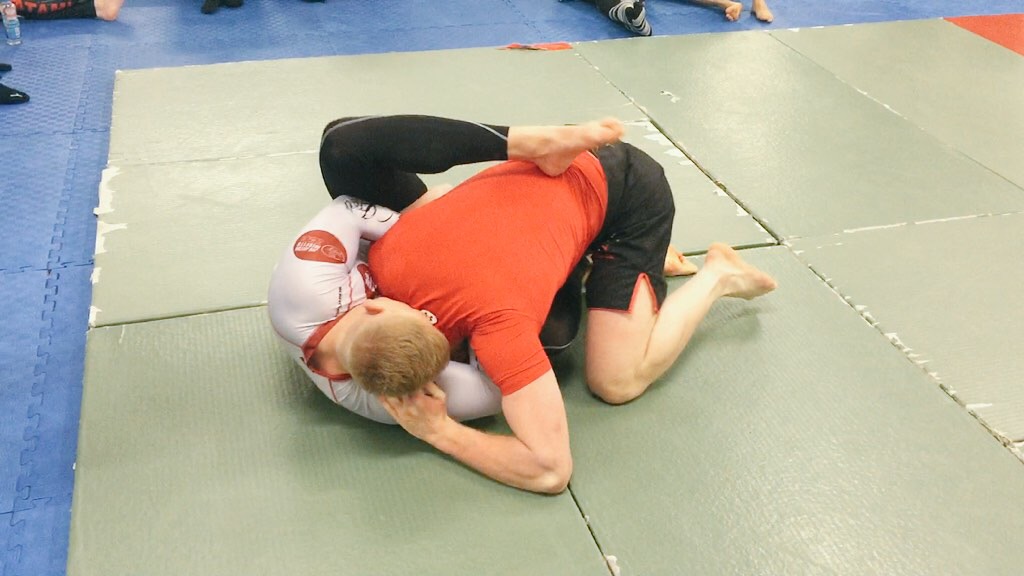 Kev locking on a guillotine choke against his first opponent.