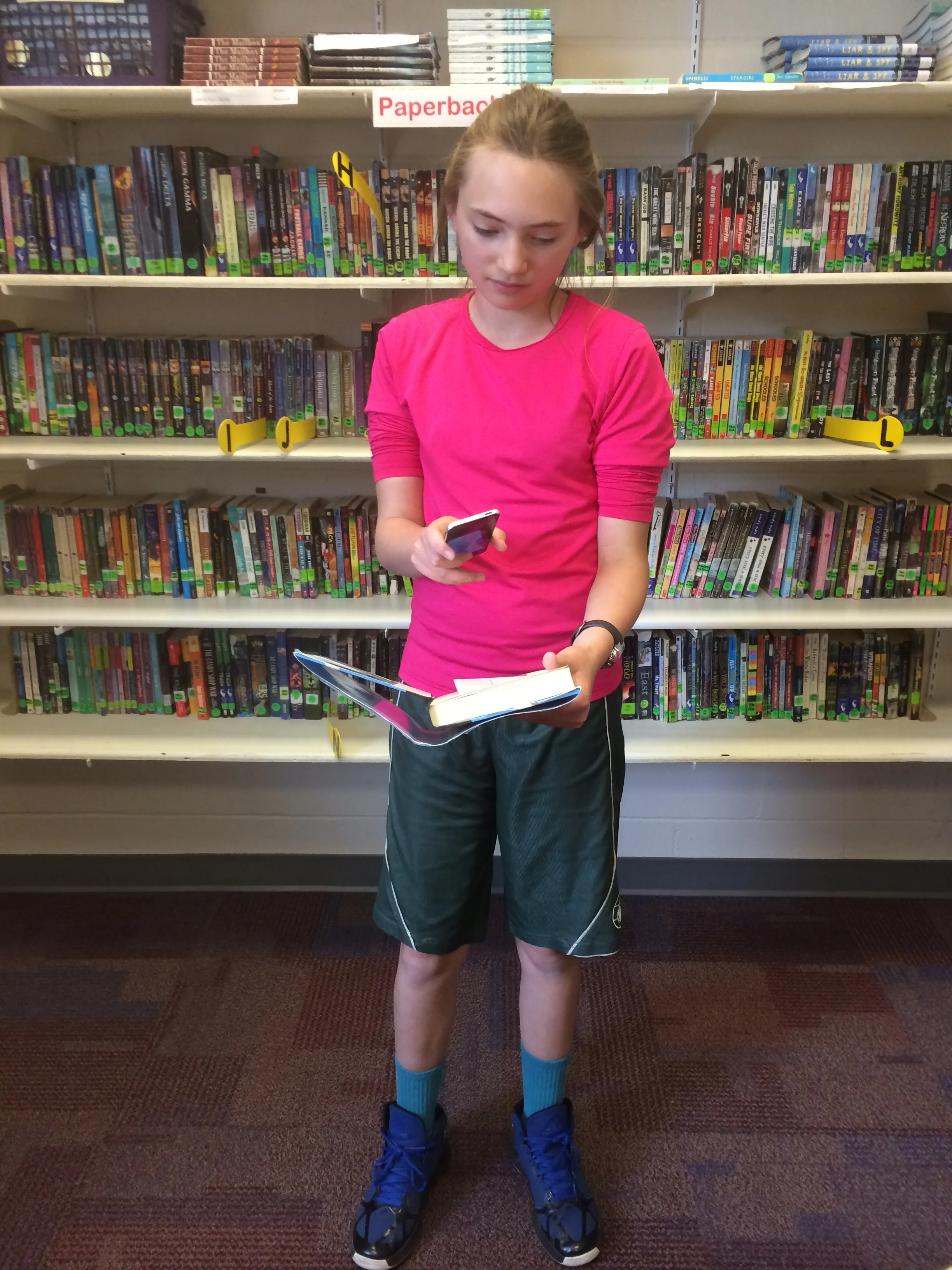 A student scans the QR code in a library book.