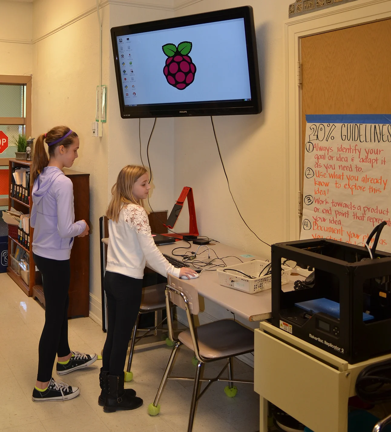 Students prepare to use the 3-D printer in the Maker Space.