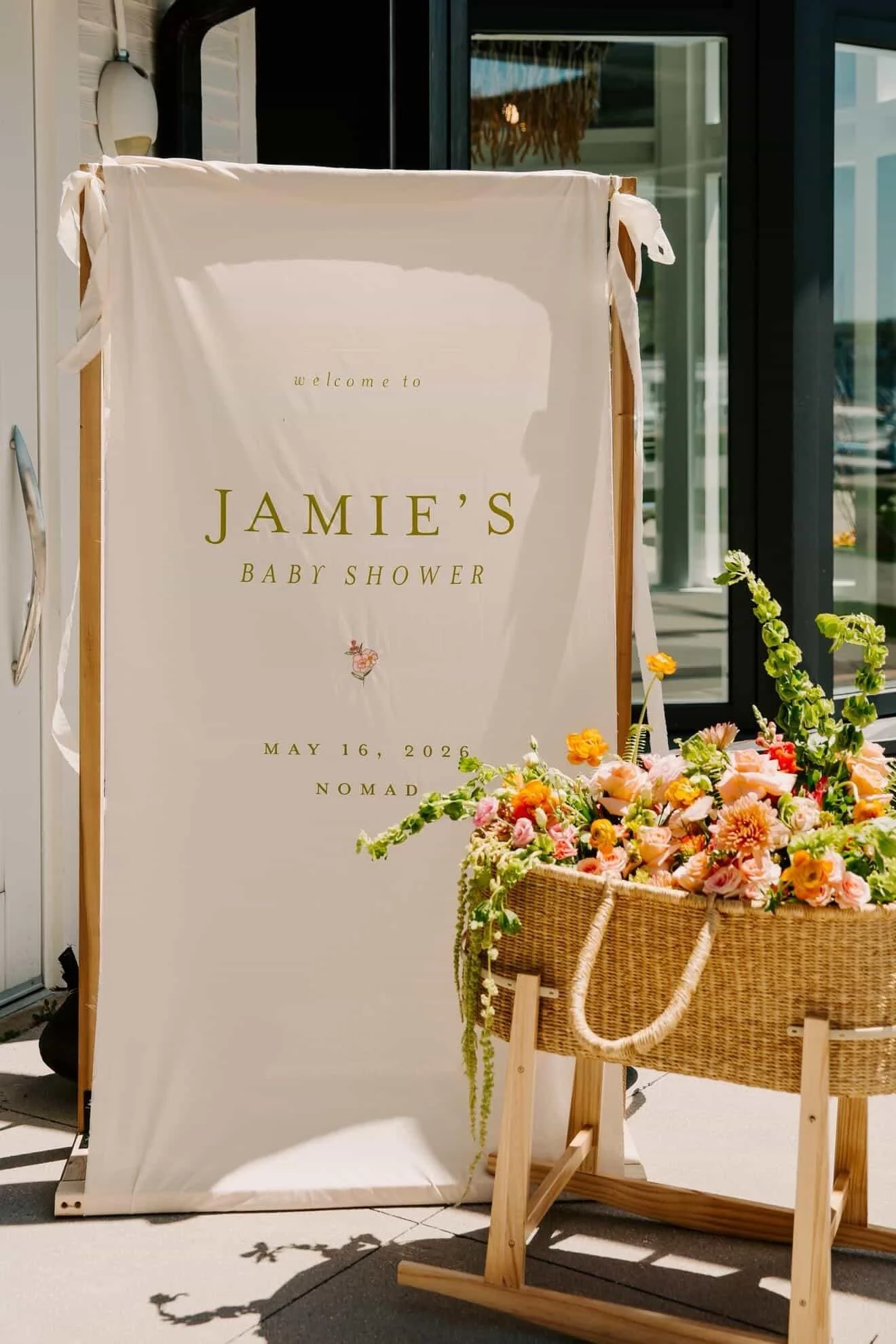 fabric welcome sign with embroidered flowers and chartreuse lettering
