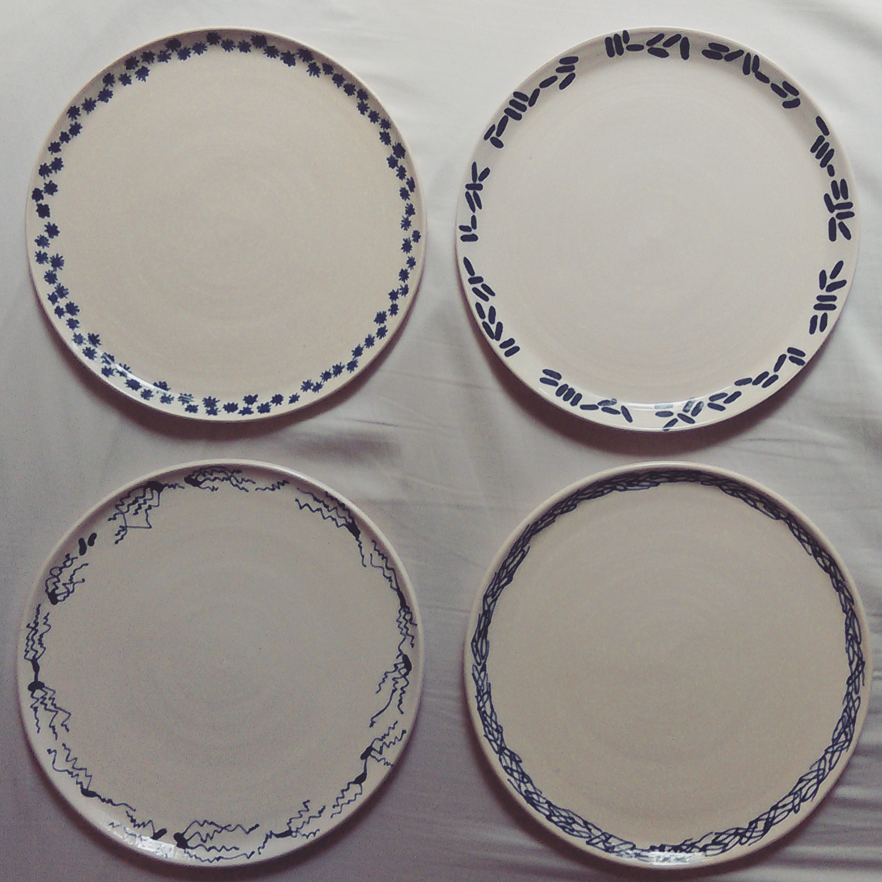 Buster's Plates , 2015, glazed earthenware, approximately 9”x9”x.5” each (clockwise from upper left - Norovirus, E. coli, Cholera, Typhoid fever)