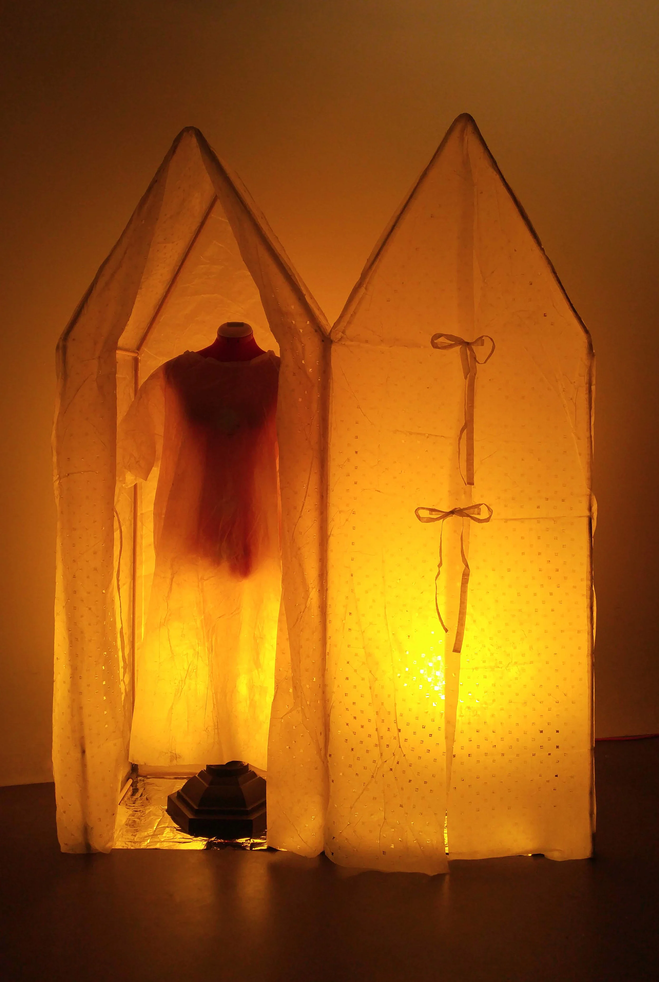 “Healing House II,” Laser etched silk, beeswax, sewing bust, light, 72” x 50,” 2018