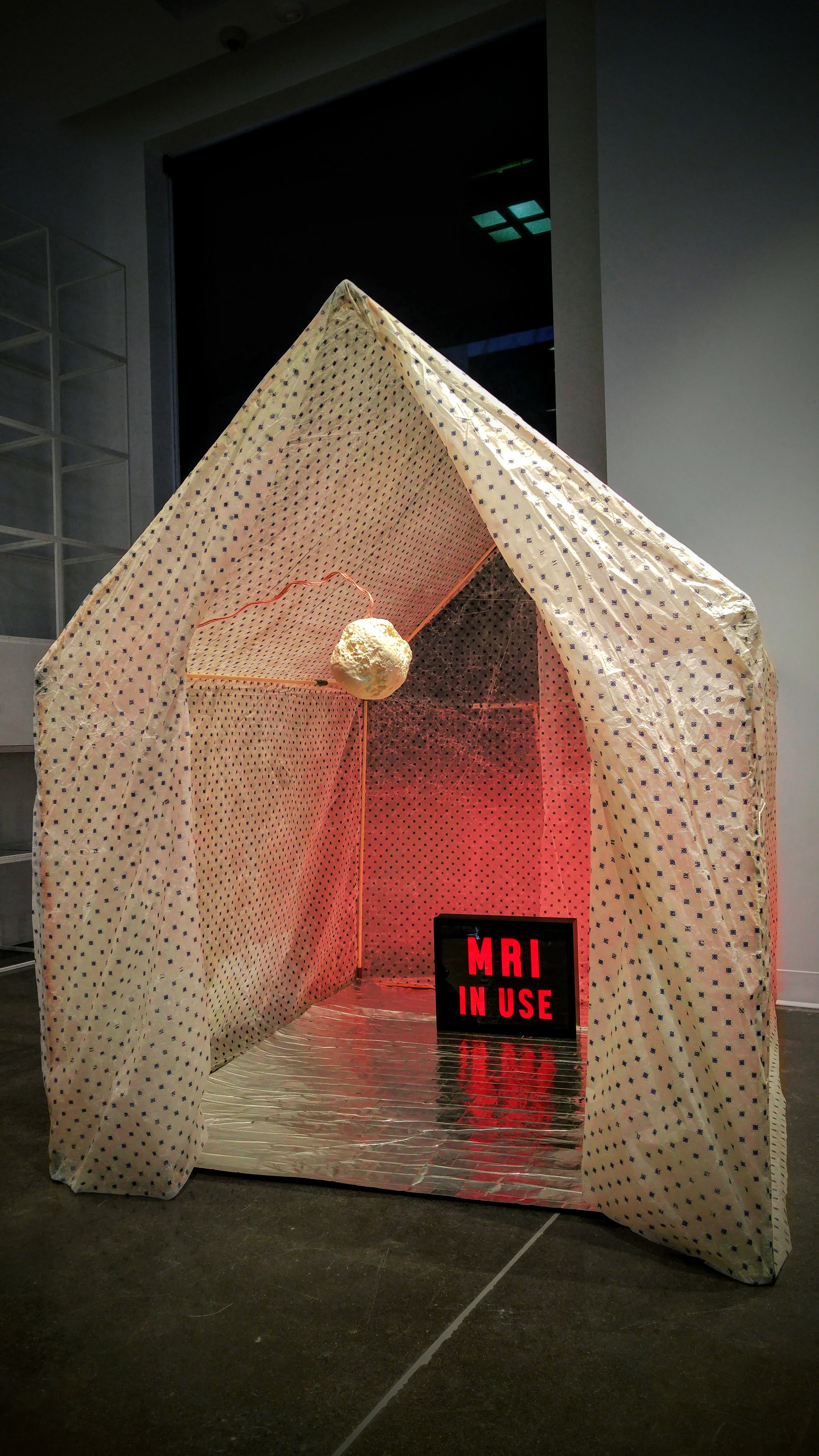 “Healing House I,” Beeswax, silk, light box, vibrational sound, 60” x 60” x 65,” 2018
