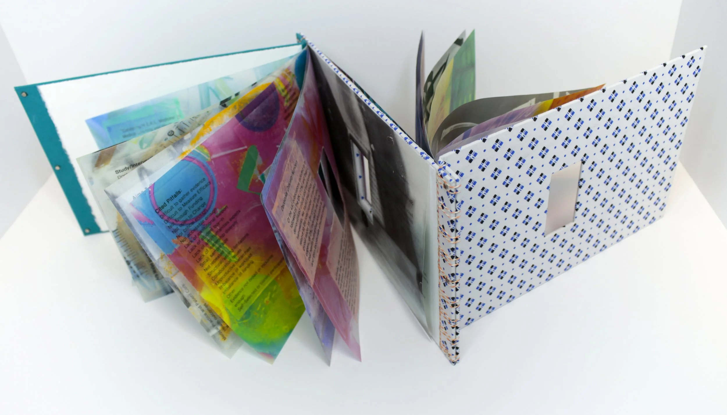 Medical // Humanities Volumes I & II , Artist’s Book, encaustic transfer on silk, hospital gown, and scrubs, 11.5” x 7,” 2024. Text by Suze Berkout, Sarah de Leeuw, and Darian Goldin Stahl.