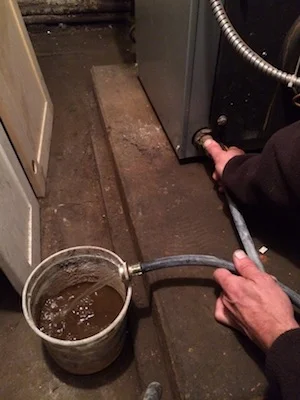 HM drains many buckets of rusty water.