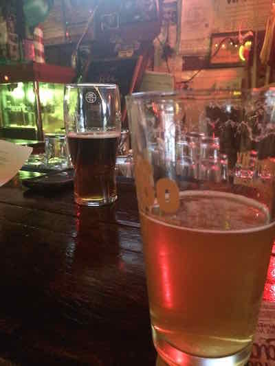The cycle of life: HM reviews the day's blog post over a beer that will be recycled in the very toilet he fixed.