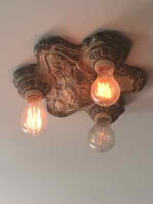 As soon as we closed on our house, I started collecting old light fixtures from flea markets. HM was not pleased. But now he proudly shows off the results – like this one in our living room – AS IF IT WAS HIS IDEA.