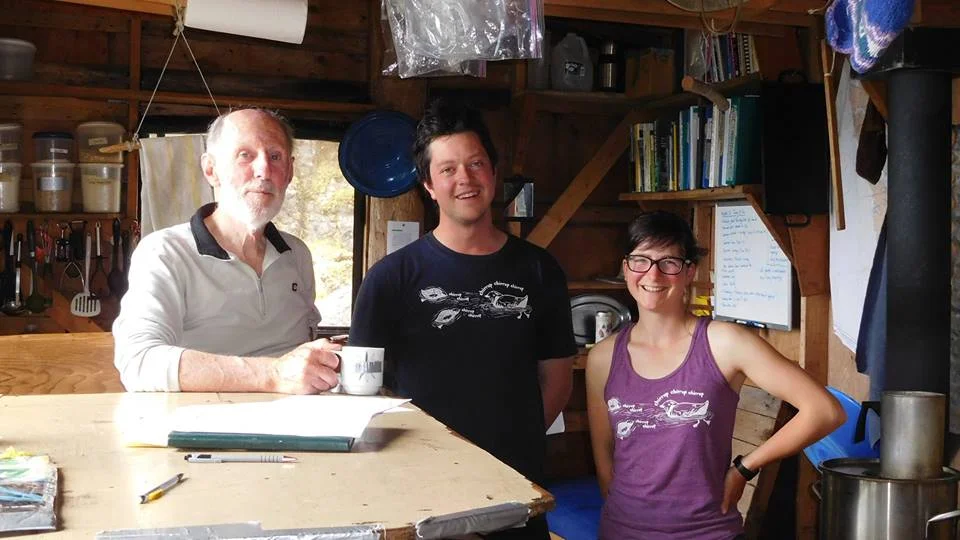 2016 Field Staff, James MacKinnon and Viv Pattison, model our shirts in the LBCS cook cabin on East Limestone Island with co-founder and longtime friend Tony Gaston.