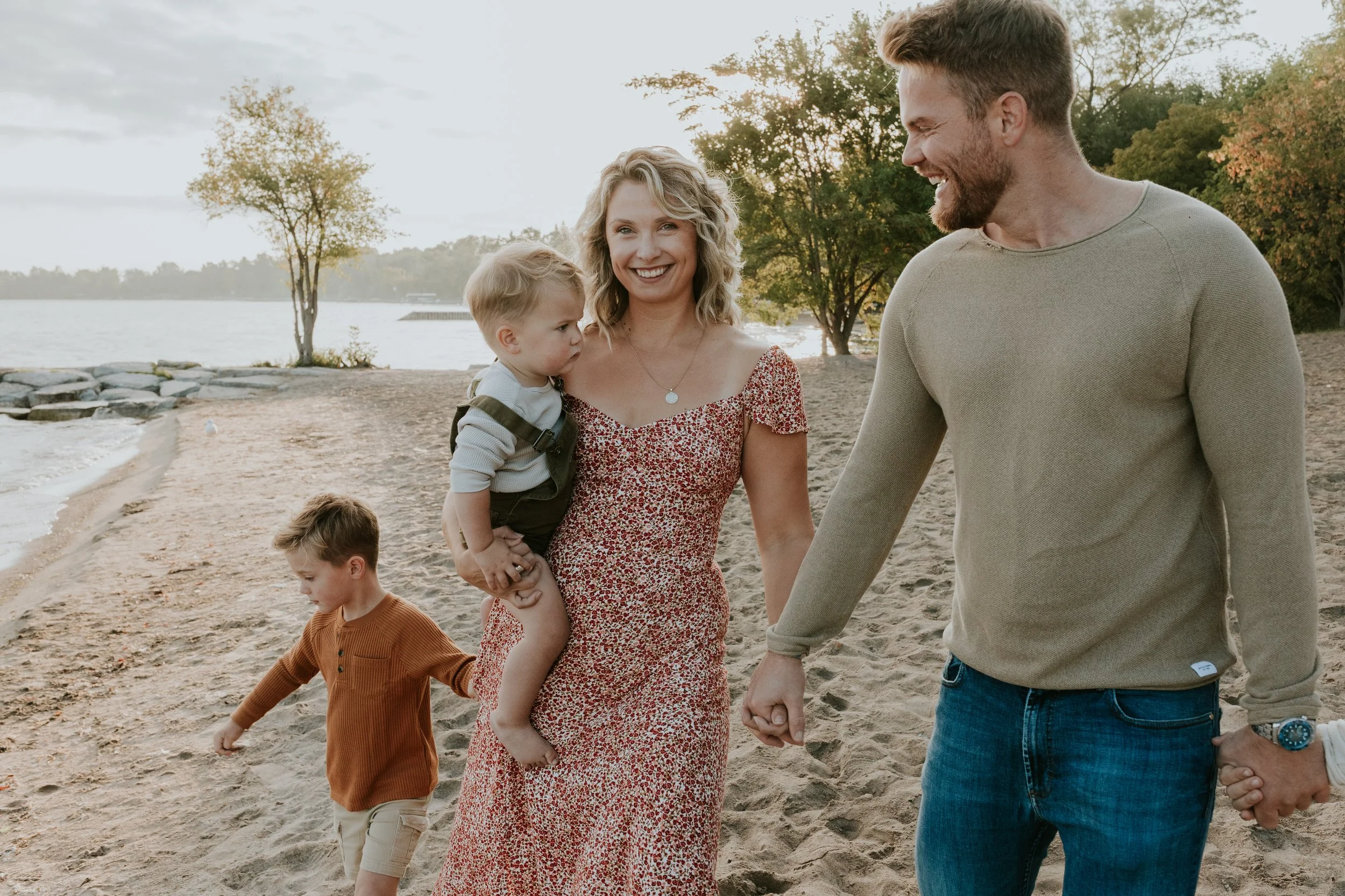 family walking along de la salle beach in georgina with mum smiling for family photos