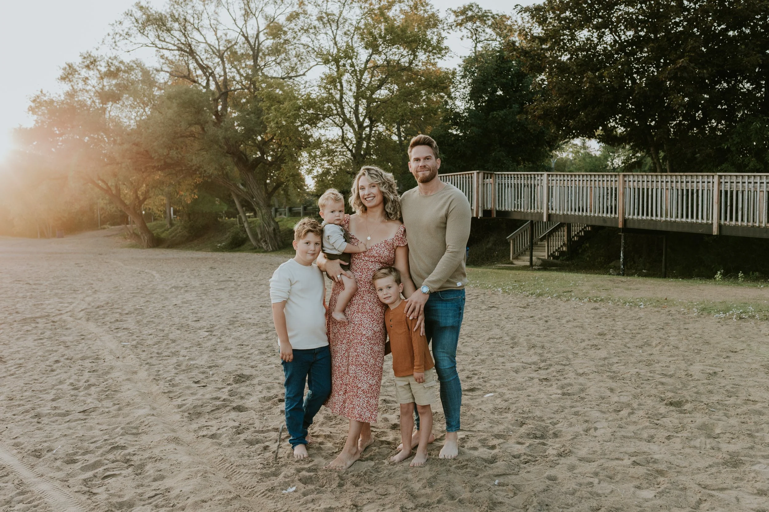 Family at de la salle beach in georgina ontario at sunrise barefoot in the sand