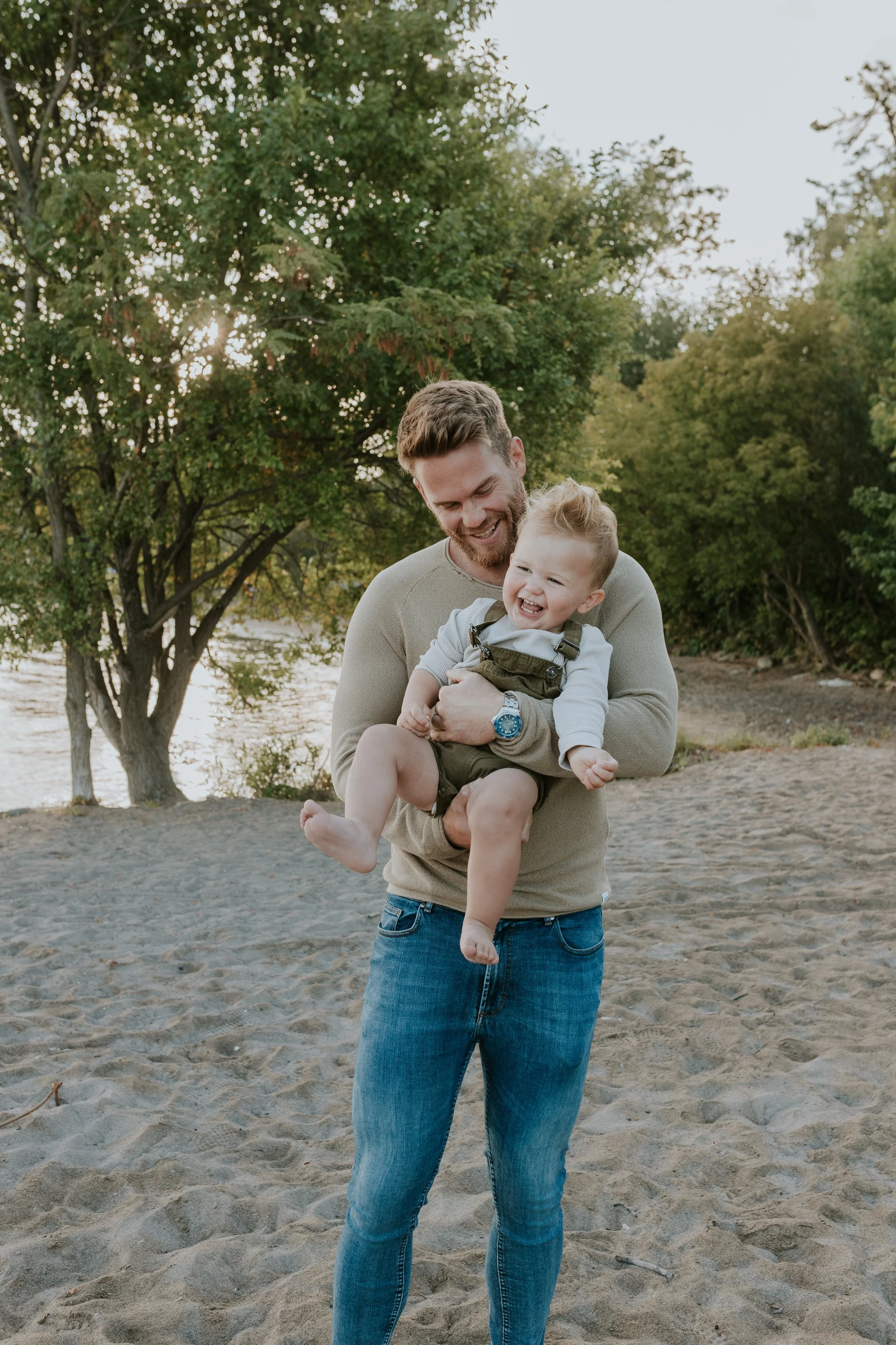 dad and son laughing at de la salle beach in georgina during a mini photo shoot
