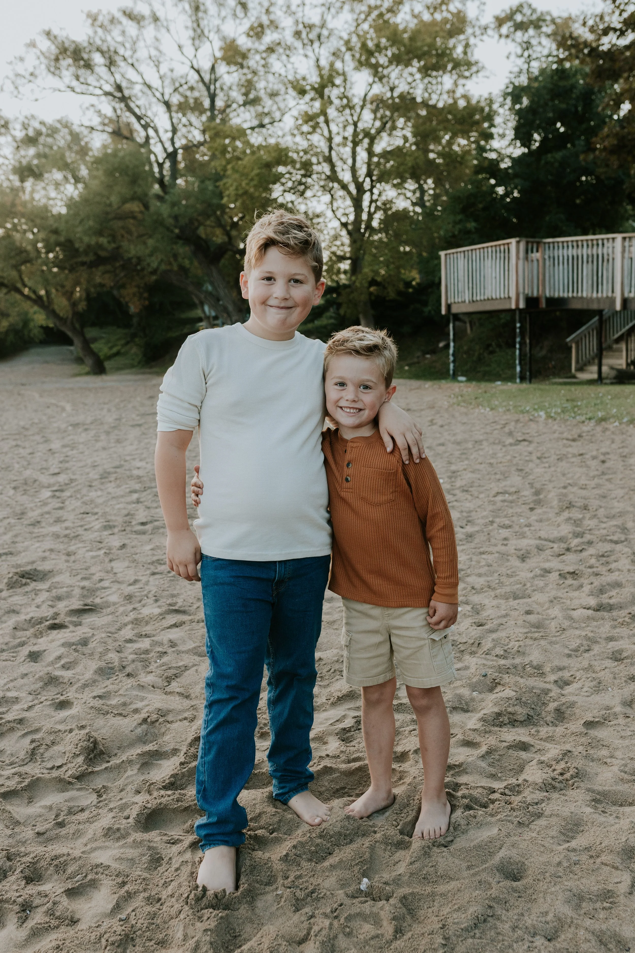 young brothers together on the beach at de la salle in georgina ontario for family photo shoot