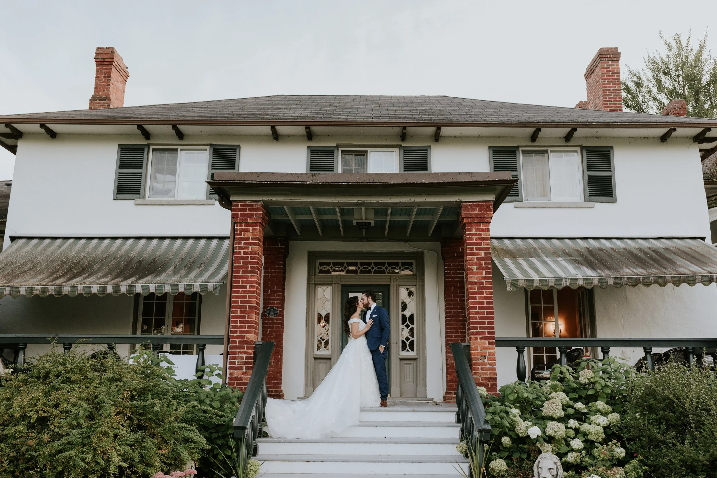 bride and groom portraits outside the manor house at the briars resort in georgina ontario