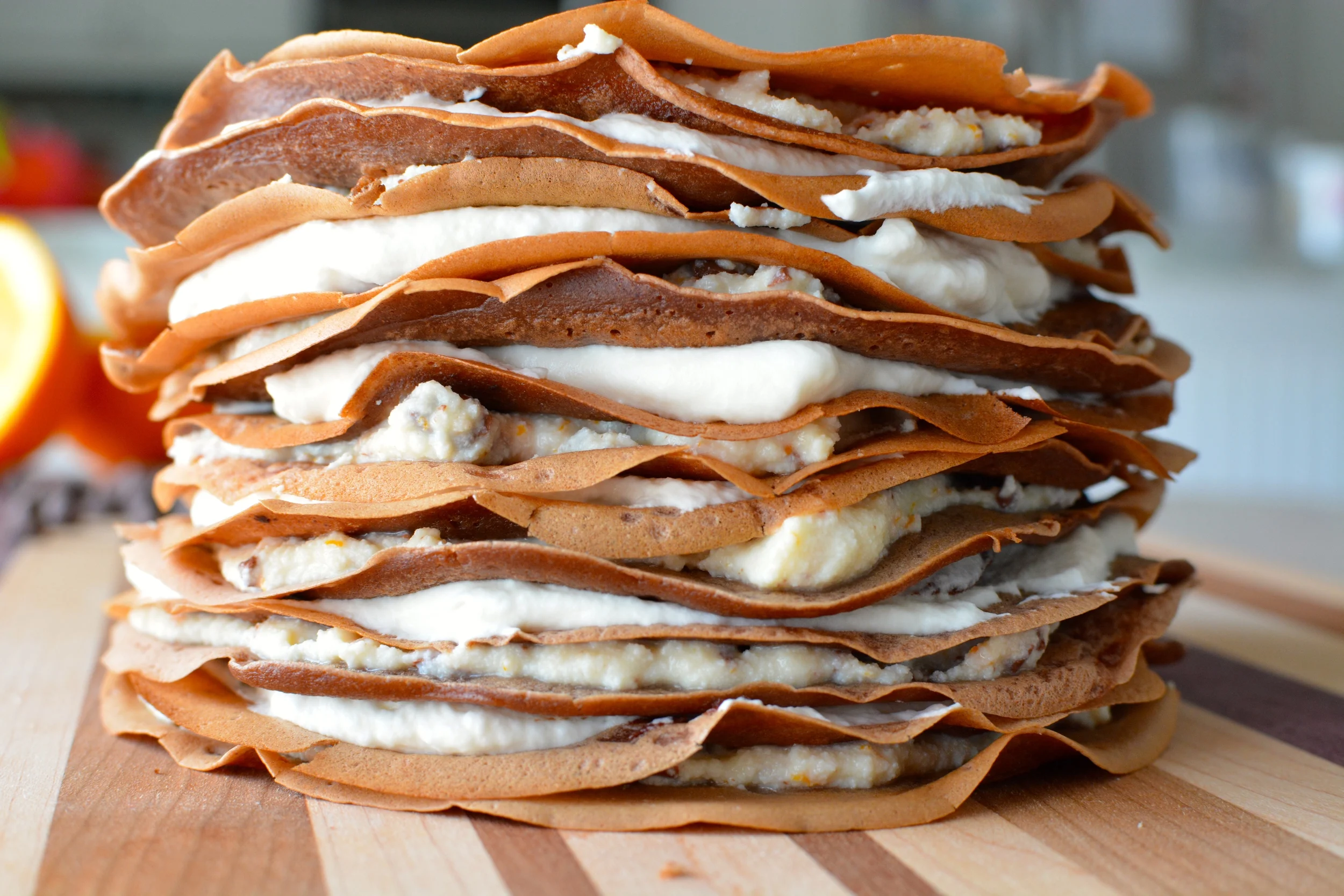 Chocolate Cannoli Crepe Cake with Vanilla Whipped Cream, Orange Cream Sauce and Chocolate Ganache