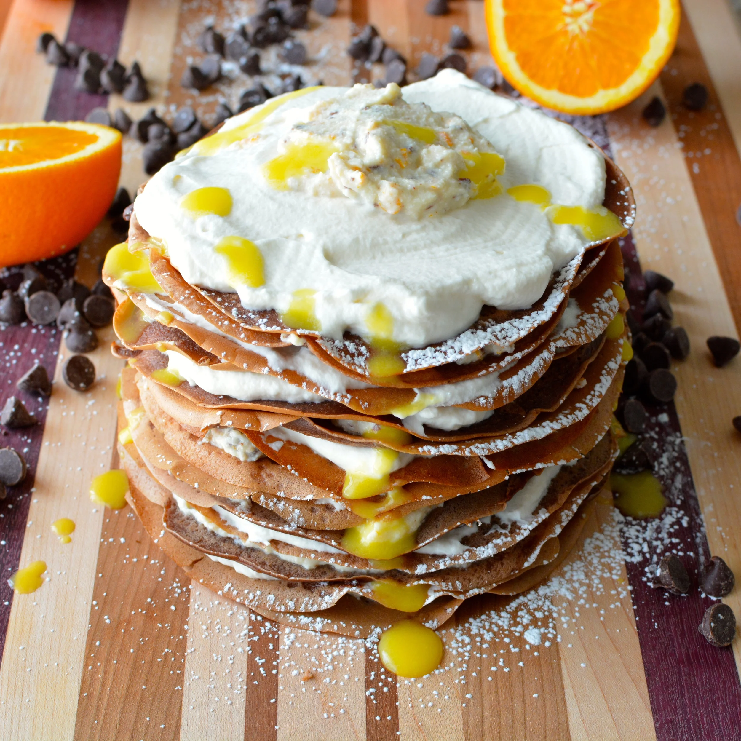 Chocolate Cannoli Crepe Cake with Vanilla Whipped Cream, Orange Cream Sauce and Chocolate Ganache