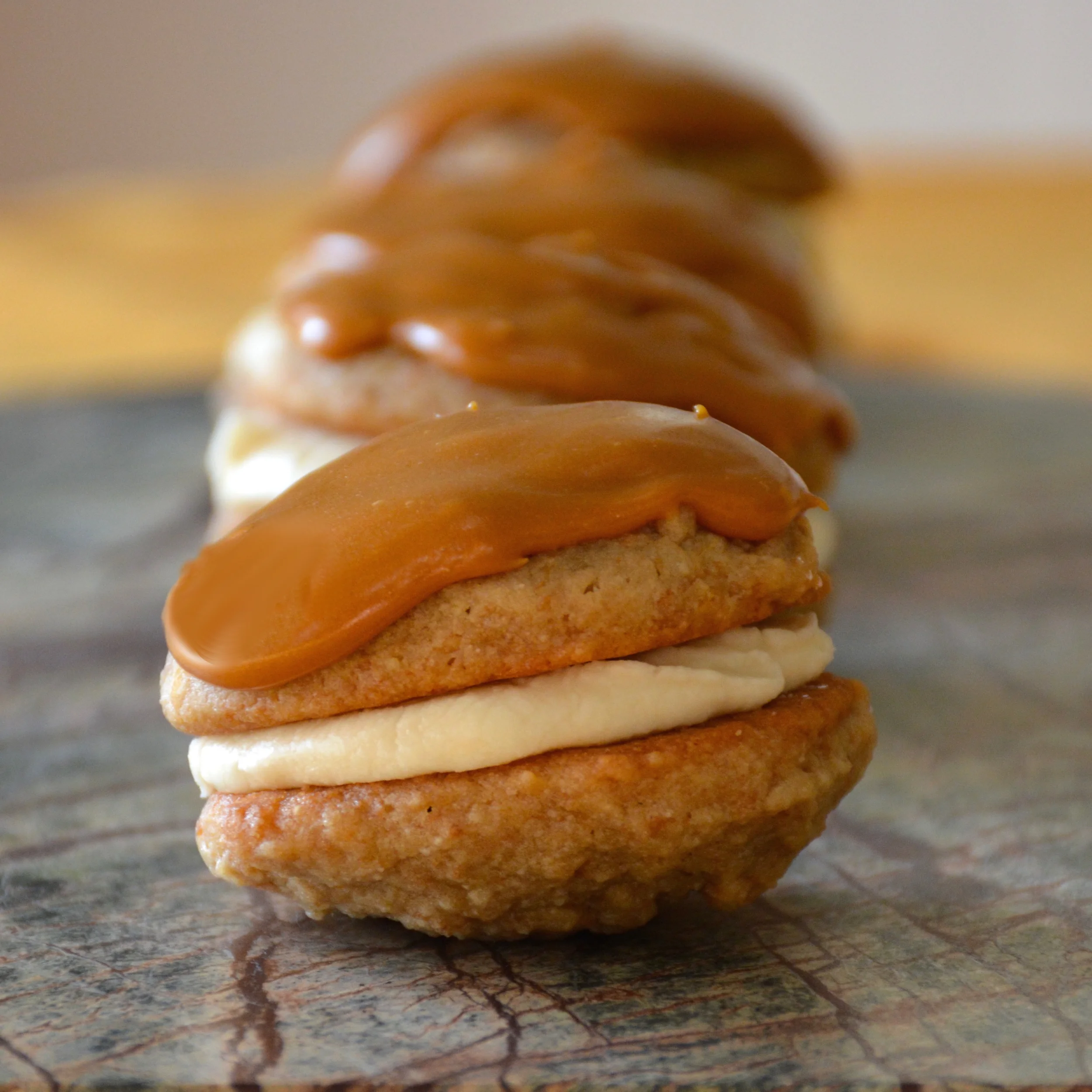 Banoffee Inspired Cookies - Banana Cookies with Vanilla Banana Cream Filling and Dulce de Leche Frosting