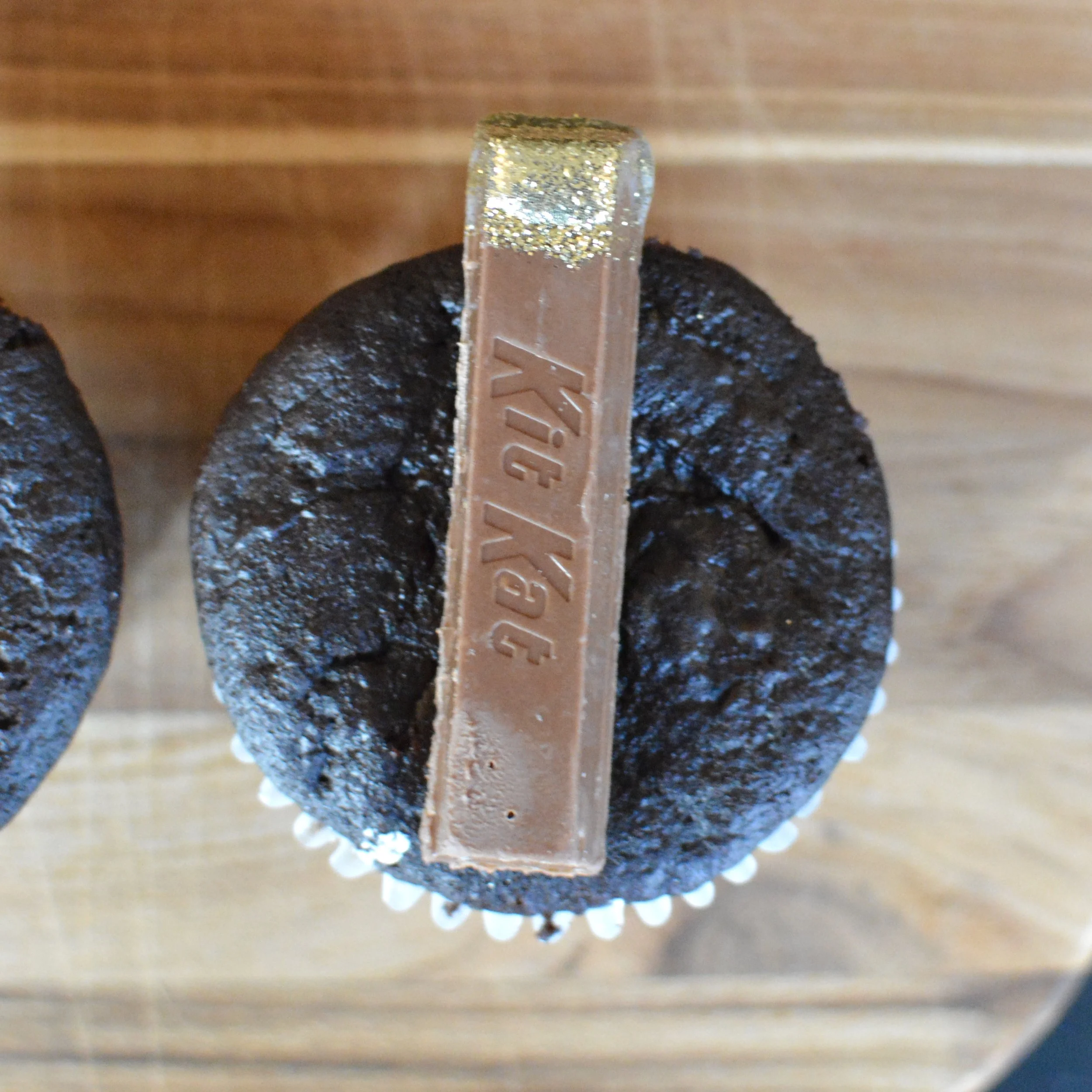 Gold Kit Kat positioned on cupcake