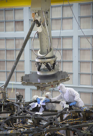 Inside a massive clean room at NASA's Goddard Space Flight Center in Greenbelt, Maryland the James Webb Space Telescope Team prepared for the first flight mirror's installation onto the telescope structure. Credits: NASA/Chris Gunn