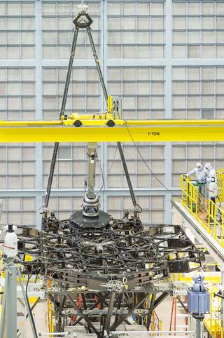 The James Webb Space Telescope team successfully installed the first flight mirror onto the telescope structure at NASA's Goddard Space Flight Center in Greenbelt, Maryland. Credits: NASA/Chris Gunn