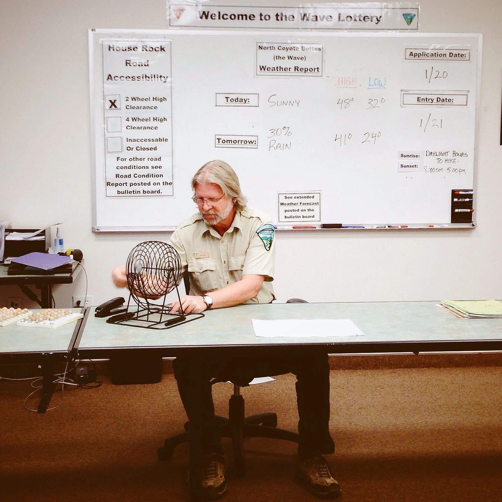 The very serious ranger mixing up the lottery balls.