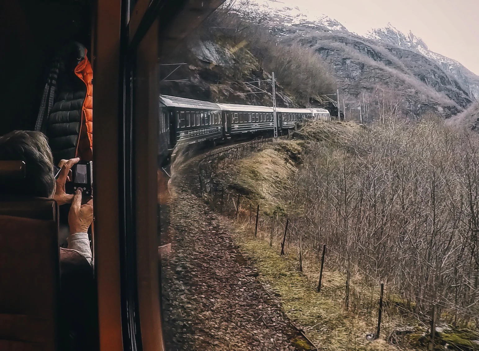 A tourist capturing the view before the train enters a tunnel