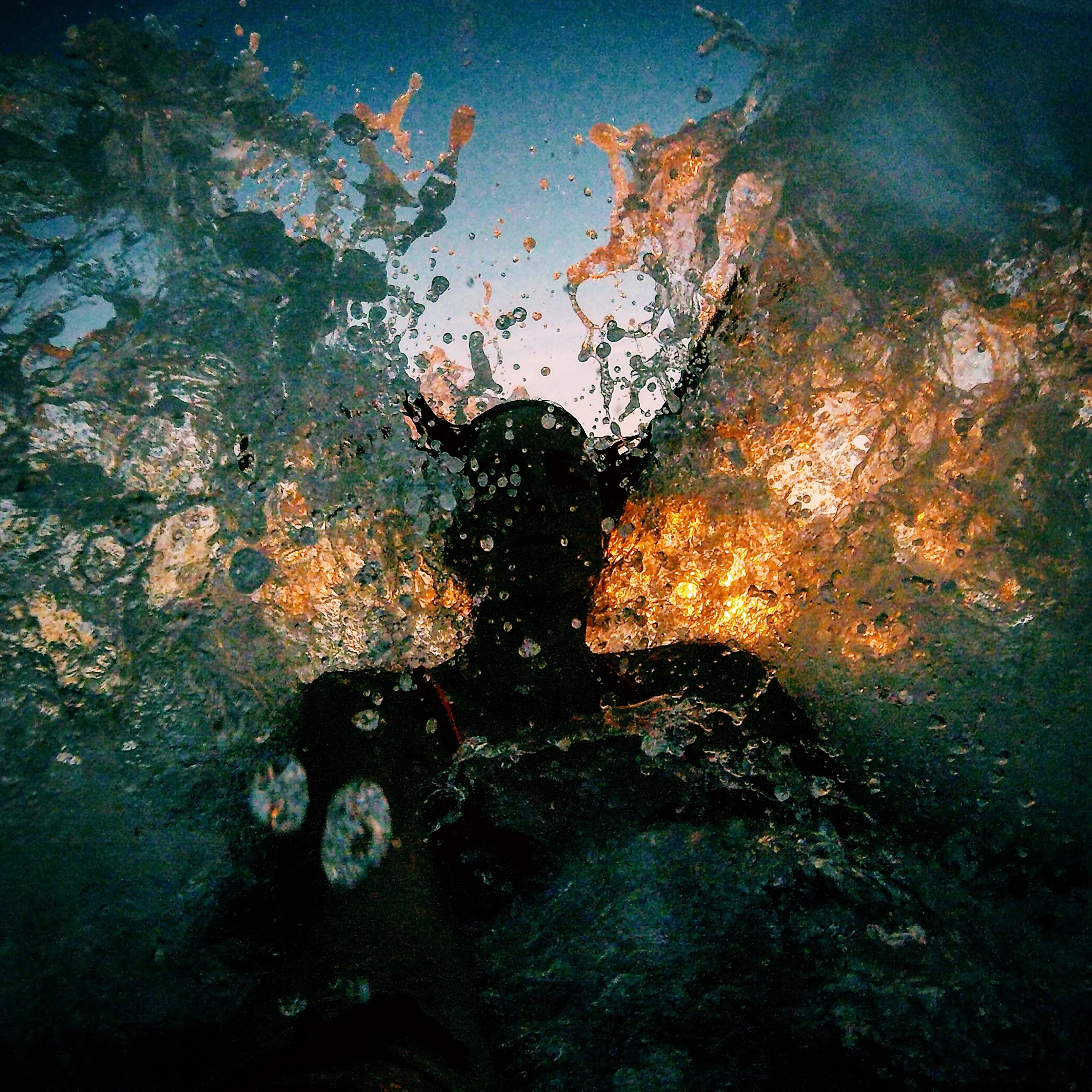 Crashing into the wave during sunset