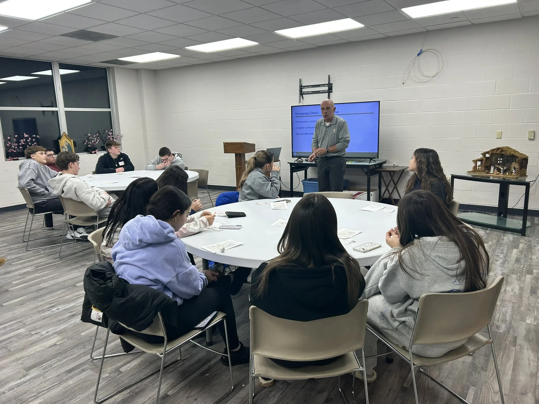 Deacon Colm with 9th grade.JPEG